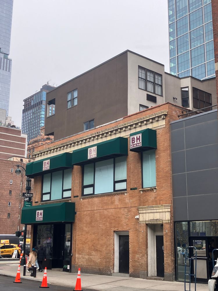 Photo shows the weird looking, stylistically inconsistent apartments added on top of the brick building housing B&H Photo Video on 9th Ave and W 34th St