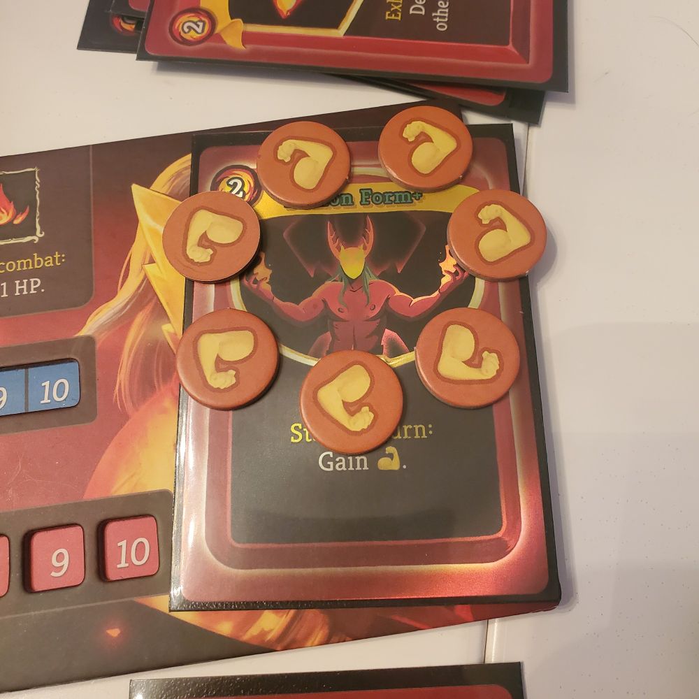 the Demon Form card in the Ironclad deck of the video game / board game Slay the Spire. Each turn gains an arm token which adds +1 damage for each attack. By the final boss in the final round, I had accumulated 7 arm tokens (too many arms) and I arranged the arm tokens in a wheel around the card 