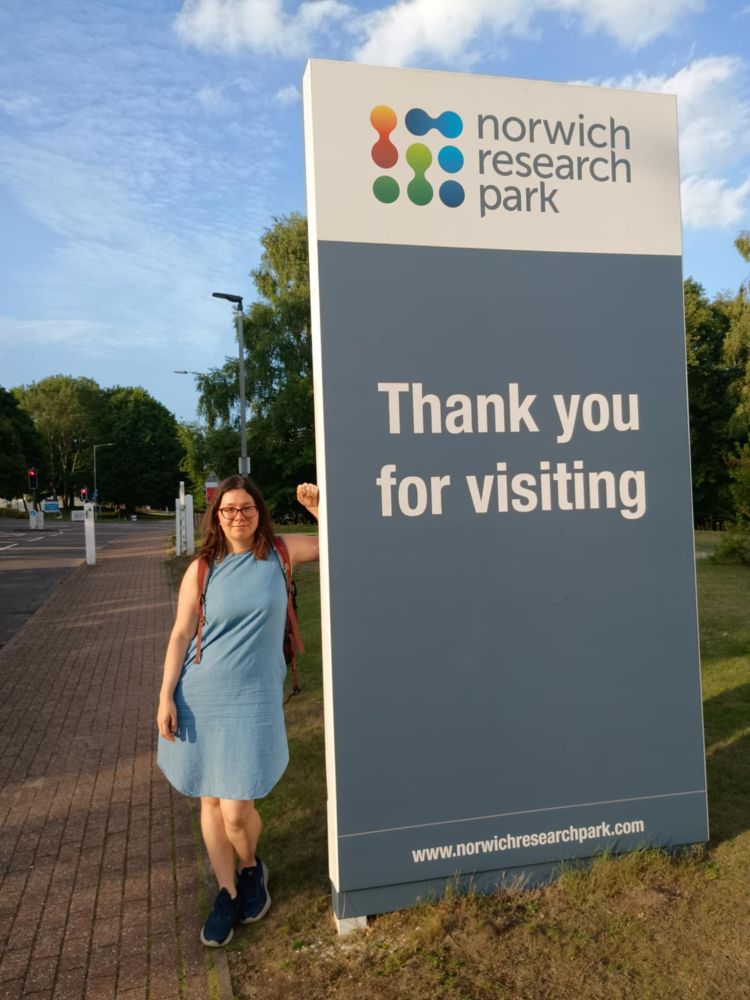 me standing next to a big sign saying "Norwich Research Park. Thank you for visiting"