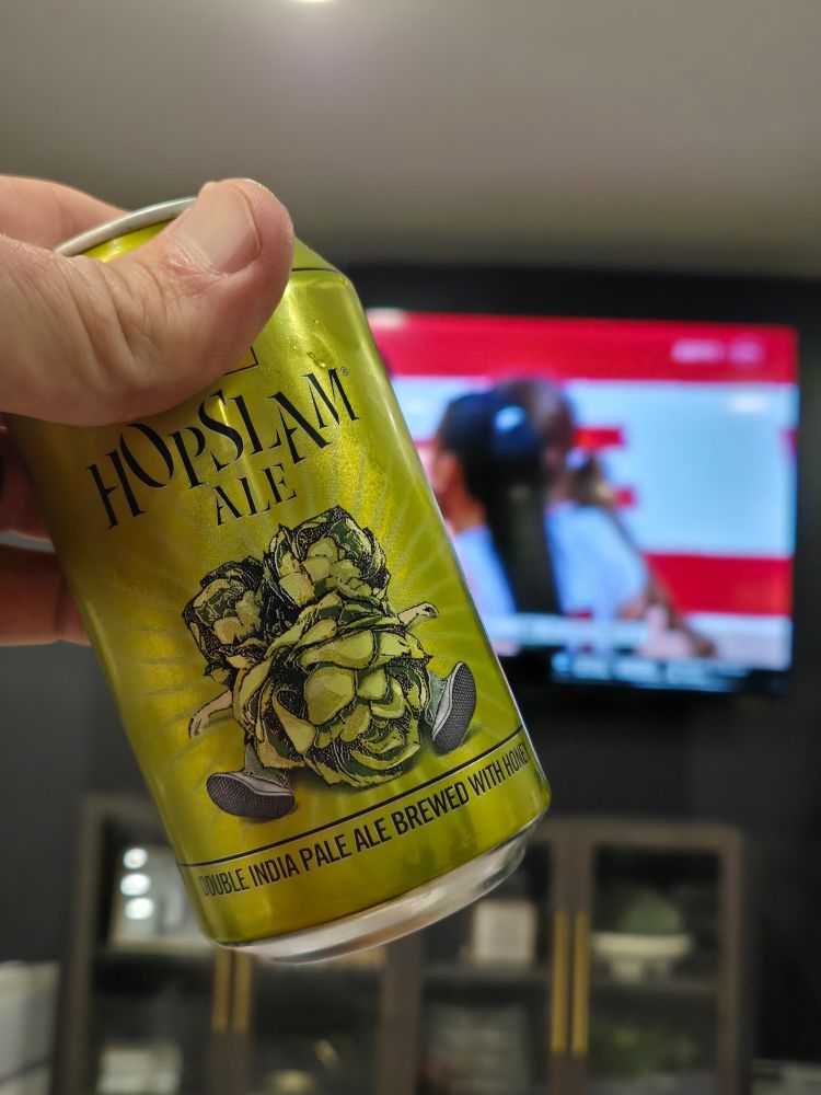 Bell's Hoplslam in front of a TV showing the amazing, NCAA volleyball Lincoln regional most outstanding player: Harper Murray