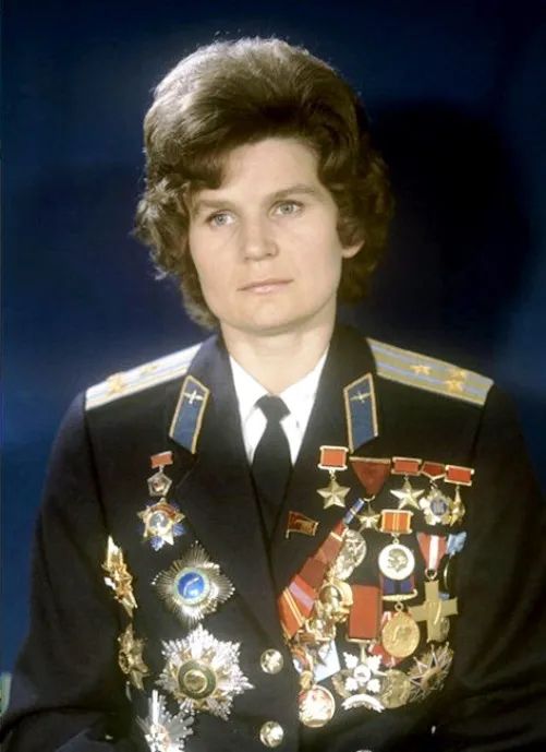 Heroine of the Cosmos – Valentina Tereshkova Decorated with Honors

This striking color photograph features Valentina Tereshkova, the first woman in space, wearing a formal military uniform adorned with an impressive collection of medals, ribbons, and Soviet insignia. Captured in the years following her groundbreaking 1963 mission aboard Vostok 6, this portrait underscores how Tereshkova’s historic spaceflight transcended scientific achievement and became a defining symbol of national pride, ideological triumph, and global inspiration. Her stoic expression and polished appearance reflect the dual role she assumed in the aftermath of her flight—both as a cosmonaut and as a celebrated political and cultural figure within the Soviet Union.

Prominently displayed on her uniform are the Hero of the Soviet Union medal and the Order of Lenin, two of the highest honors awarded by the USSR. These decorations recognize not only her bravery in venturing into space at just 26 years old, but also her significance as a symbol of gender progress in a world where female astronauts were still decades away in other nations. The photograph captures a moment when Tereshkova was no longer merely a cosmonaut, but a state icon, used in Soviet propaganda to promote the ideal of gender equality under communism.

Yet the image also conveys personal accomplishment. Tereshkova came from humble beginnings—raised in a working-class family and employed in a textile mill before becoming a paratrooper and eventually a cosmonaut. Her rise to global prominence was a remarkable example of upward mobility through merit and state sponsorship, illustrating the USSR’s emphasis on showcasing its social and scientific superiority during the Cold War.

Beyond Soviet borders, Tereshkova became a global figurehead for women in science and leadership, eventually serving in prominent political roles. She later came to represent in the ongoing fight for equity, representation, and space exploration.