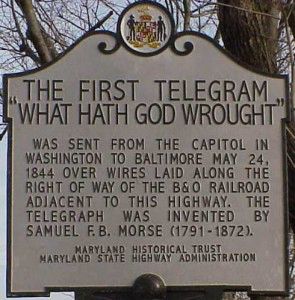 Historic Marker: The First Telegram Sent by Samuel Morse

This image displays a historical roadside marker commemorating one of the most pivotal moments in communication history: the transmission of the first telegram by Samuel F. B. Morse on May 24, 1844. The plaque, issued by the Maryland Historical Trust and the Maryland State Highway Administration, is situated along the route used by the B&O Railroad—the same path along which Morse’s telegraph wires were laid between Washington, D.C., and Baltimore. The marker reads: “The First Telegram ‘What Hath God Wrought’ was sent from the Capitol in Washington to Baltimore May 24, 1844 over wires laid along the right of way of the B&O Railroad adjacent to this highway. The telegraph was invented by Samuel F. B. Morse (1791–1872).” This succinct dedication encapsulates a moment when the world changed forever. With a simple biblical phrase transmitted through electrical pulses, Morse inaugurated a new era in which information could travel faster than any human or horse, bypassing the limitations of geography. This advancement laid the foundation for the global communication networks that define the modern world. Before the telegraph, communication over long distances was dependent on physical transport, but Morse’s system of electromagnetically-controlled signals allowed for near-instantaneous message delivery—a breakthrough that influenced everything from journalism and commerce to diplomacy and warfare. The selection of the phrase “What hath God wrought?” (Numbers 23:23) added a solemn and reverent tone to the technological leap, suggesting a spiritual awe at the human ability to harness nature’s invisible forces. This historical marker not only preserves the memory of Morse’s innovation but also stands as a testament to the interplay of faith, technology, and infrastructure in the shaping of modern civilization.