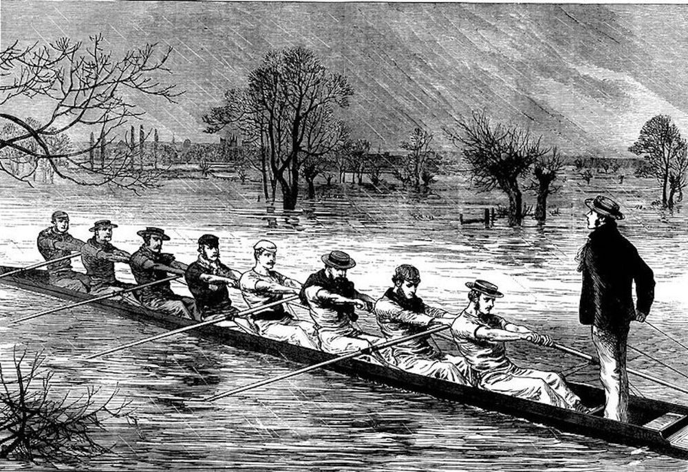 The Historic Beginning – The Oxford-Cambridge Boat Race of 1829

This illustration captures the inaugural Oxford-Cambridge Boat Race, held on June 10, 1829, on a flooded stretch of the River Thames near Henley-on-Thames. Depicted in period-appropriate attire, the rowers from each university are seated in long, slender racing shells, powered by precise and rhythmic oar strokes. At the stern, the coxswain stands upright, steering and calling cadence to synchronize the team’s efforts. The landscape around them is barren and flooded, a subtle but telling detail that emphasizes the perseverance of tradition despite adverse conditions. This iconic rivalry between Britain’s two most prestigious universities began not as a formal regatta but as a friendly challenge between old classmates: Charles Merivale of Cambridge and Charles Wordsworth of Oxford. The outcome of that first race—Oxford’s victory—ignited a sporting legacy that would grow into one of the world’s most celebrated and enduring contests.

The image reflects the early 19th-century values of discipline, amateur sportsmanship, and collegiate identity. The long, sweeping lines of the rowers in unison convey the strategic elegance of crew racing. This event marked a shift in how organized sports were perceived in British culture—moving from informal leisure activity to structured competition, eventually becoming a national spectacle. The race not only reinforced intercollegiate pride but also laid the groundwork for international rowing competitions and collegiate athletic programs globally.

Though modern races feature sleek composite boats, digital tracking, and international broadcasts, this image is a portal to the origins of a tradition that has endured world wars, cultural shifts, and changing athletic norms. It stands as a tribute to how a simple bet between friends became a cornerstone of British sporting heritage and a metaphor for persistence, rivalry, and unity through sport.