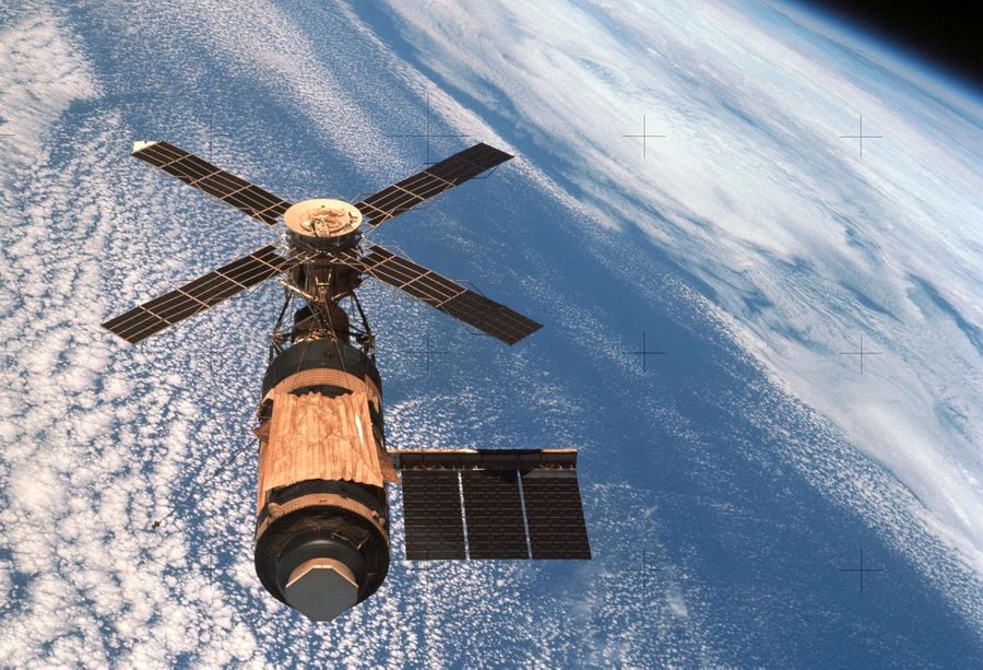 Skylab in Orbit—A Pioneering Step in Space Habitation

This image captures NASA’s Skylab, America’s first space station, as it orbits Earth above a cloud-covered expanse. Launched in 1973 atop the final Saturn V rocket, Skylab was a monumental step forward in space habitation. Its cylindrical structure was once a repurposed Saturn V third stage, converted into a habitable space workshop that would support long-duration missions in low Earth orbit. Skylab’s solar arrays stretch outward like mechanical wings, collecting energy to power its onboard systems. The station carried a suite of scientific instruments, including the Apollo Telescope Mount, which allowed astronauts to observe solar flares, coronal mass ejections, and other dynamic processes on the Sun. 

During its operational period from 1973 to 1974, three astronaut crews visited Skylab, conducting groundbreaking experiments in biomedical science, solar physics, and materials research—yielding a new understanding of how the human body adapts to microgravity. Skylab was also the first platform to test food preparation, waste management, and exercise routines for extended human occupation in space, paving the way for future stations like Mir and the International Space Station. Visible wear on its golden protective shielding reveals the damage Skylab suffered during launch when a micrometeoroid shield detached, compromising its cooling system and solar power. Nonetheless, emergency spacewalks and repairs made by the first crew ensured the mission’s success. This image immortalizes Skylab not just as a scientific outpost, but as a symbol of resilience, innovation, and the United States’ commitment to exploring life beyond Earth. It represents a defining chapter in humanity’s journey into the cosmos.