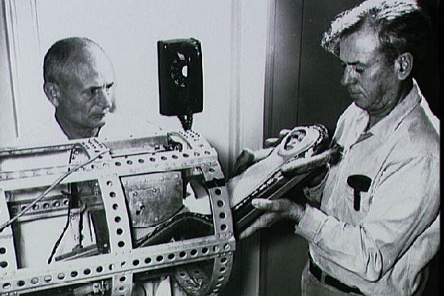 Preparing Albert II’s Capsule – Engineering the Edge of Life

This powerful image captures a pivotal and sobering behind-the-scenes moment in the development of space biology: the engineering preparation of Albert II’s capsule before his historic 1949 flight. Two technicians—members of the U.S. Army medical and aeronautical research teams—are shown handling the life-support system and containment chamber designed to carry the rhesus monkey into space. Their expressions reflect both focused precision and the weight of responsibility. This was no ordinary test; the experiment would push the boundaries of life as it was known at the time.

The capsule in their hands is a compact, cylindrical steel and aluminum container, rigged with an internal framework of padded restraints, biometric sensors, and a breathing system. One technician holds the pressure-sealed inner housing—designed to protect Albert II from the vacuum of space—while the other examines the structural integrity of the surrounding shell. The open frame is pierced with ventilation holes and mounting joints, giving it an industrial look that underscores the experimental nature of early spaceflight technology. Nearby, rudimentary analog instruments monitor vitals like pulse, body temperature, and respiratory rate, essential for capturing biometric data during the high-altitude ascent and descent.

Developed using remnants of captured German V-2 rocket parts and adapted wartime technology, this mission marked a critical transition from theoretical physics to applied biology. The engineers and scientists behind this project were stepping into uncharted territory, confronting not only the technical challenges of sending a living organism to the edge of space but also the moral questions it raised. Albert II’s brief journey and tragic end exposed both the promise and peril of this new scientific frontier. This photo freezes in time the engineering ingenuity and ethical ambiguity at the dawn of space exploration.