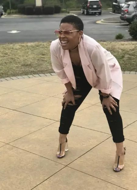 Woman squatting and squinting