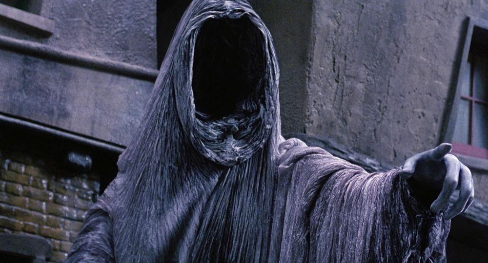 The ghost of Christmas yet to come from The Muppet Christmas Carol. A huge foreboding figured cloaked in dark and ragged robes. Their face is entirely shrouded, like looking into a black void. They silently point with long deathly pale fingers and it’s very sexy.