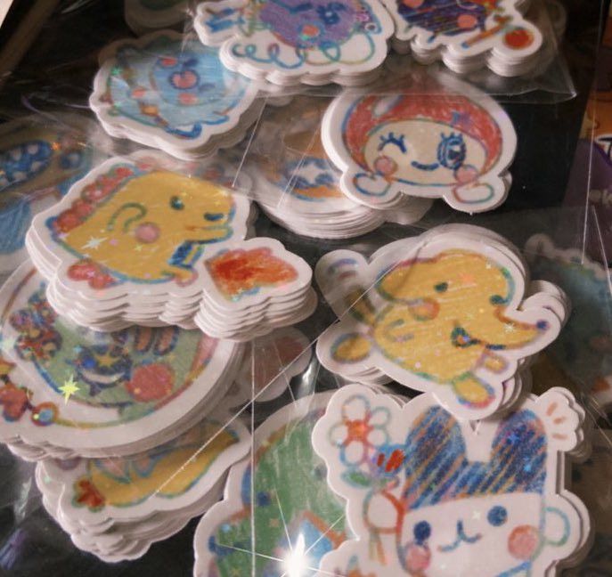 A lot of holographic stickers of various tamagotchi characters!