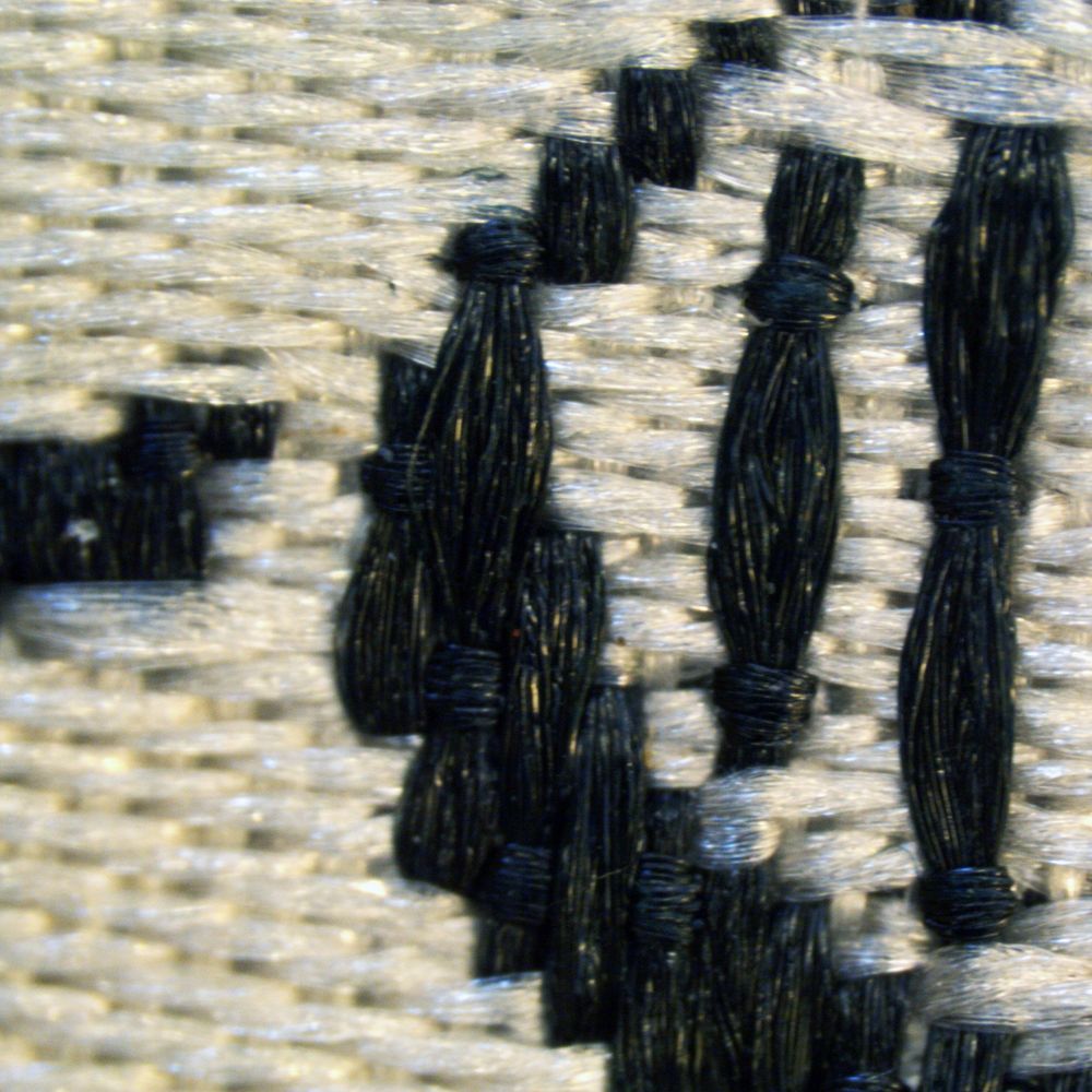 Close up image of silk fibers forming the letter C