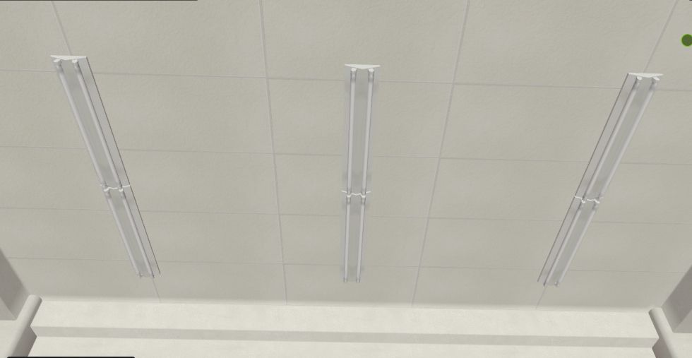 the ceiling of the entrance. A plain white tile, with six (three in the image) beam lights over 