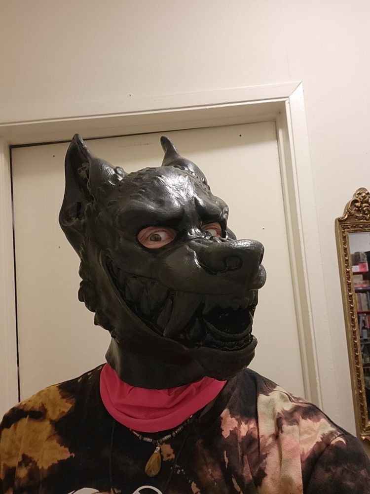 closeup of the rubber wolf hood being worn