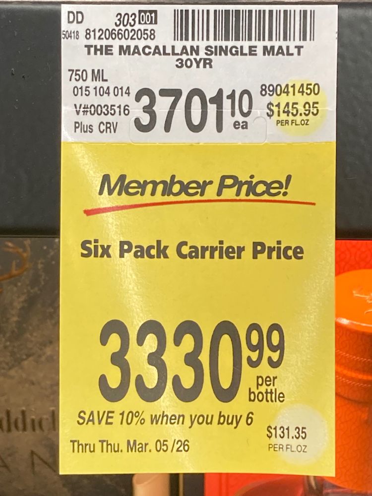 A grocery store shelf tag for bottles of The Macallan 30-year-old single malt Scotch, showing a price of $3701.10 for a 750 ml bottle. But the price per bottle if you are a member and buy six of them is only $3330.99!