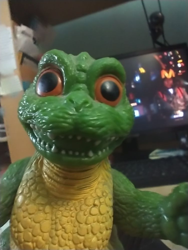 Little Godzilla bandai toy figure in front of a computer monitor, on which is playing the very poor Godzilla versus Space Godzilla movie.
