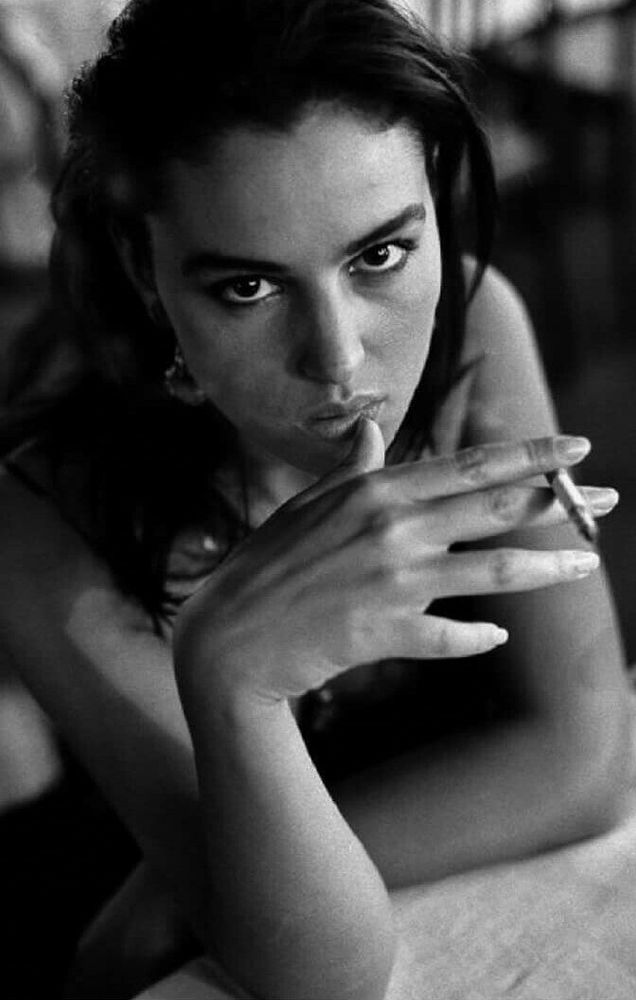 Monochrome image of Monica Bellucci holding a cigarette 