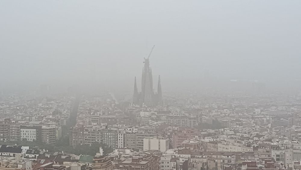 Barcelona in the rain with the silhouette of the Sagrada Familia 