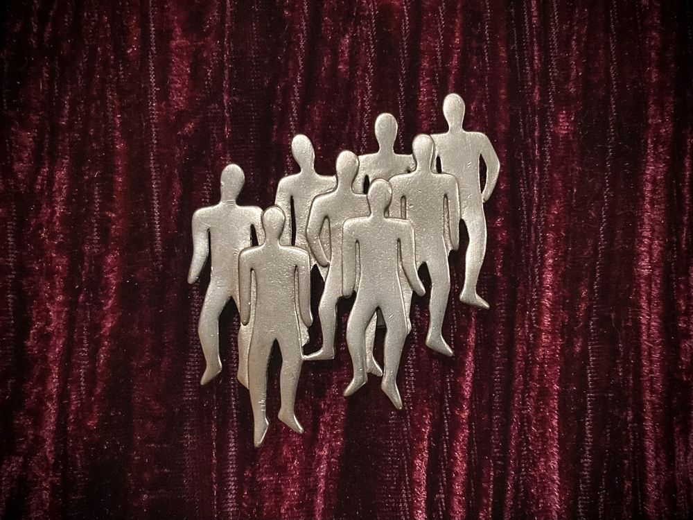 Jonette Jewelry brooch featuring eight staggered faceless silhouettes