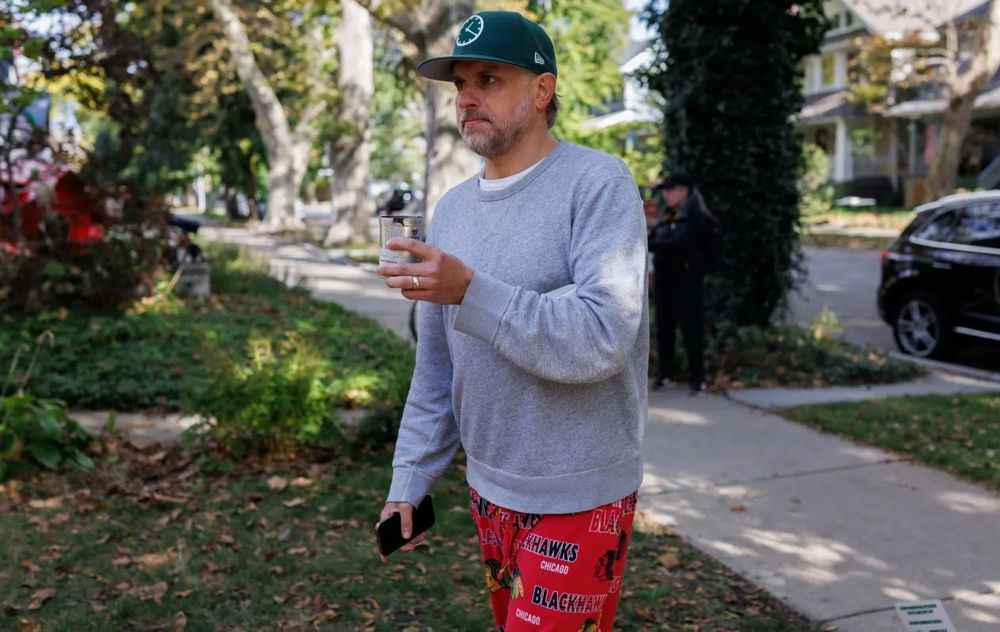 Brian Kolp, a Chicago resident, carries tear gas near his home that was used by border patrol. He ran out of his house in Blackhawks pajama pants while barefoot to yell at ICE and Border Patrol