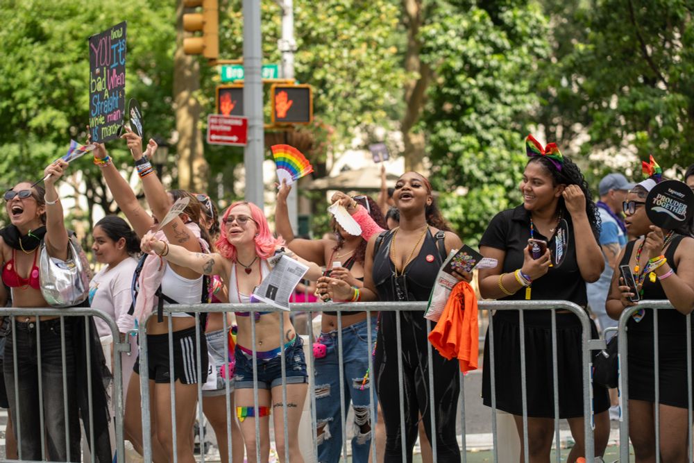 spectators at the pride parade cheering