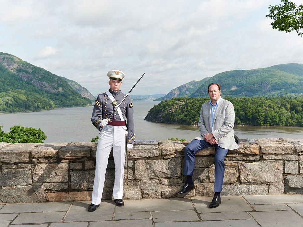 A son in uniform and a father on an overloook bridge