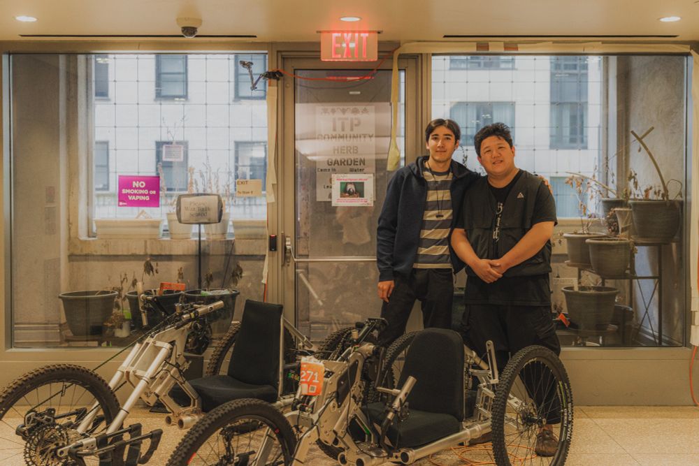 Jackson and Yuxiang standing with the adaptive bike