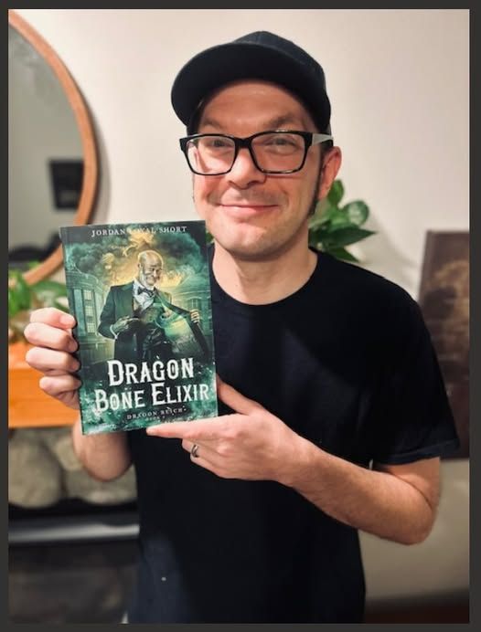 Me holding the first copy of Dragon Bone Elixir.