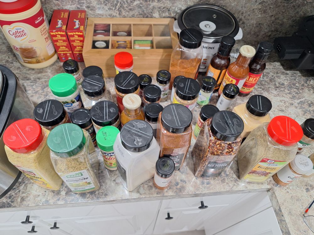 Countertop filled with jars of spices.