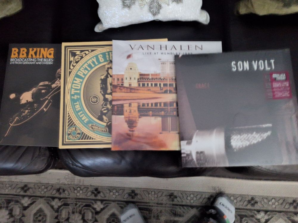 Four vinyl records fanned out from BB King, Tom Petty and the Heartbreakers, Van Halen and Son Volt.