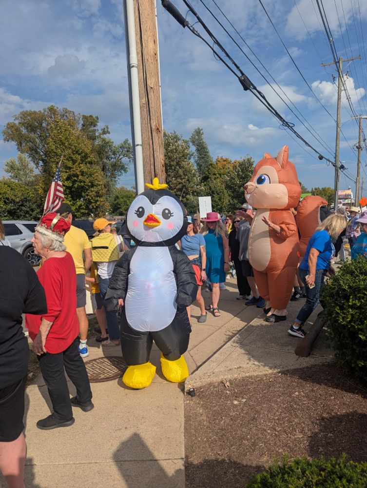 Photo of No Kings rally featuring costumed critters. 