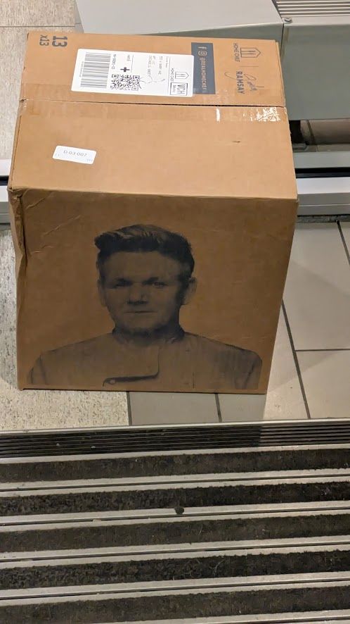  A Gordan Ramsey meal prep delivery box in a building entrance foyer. 