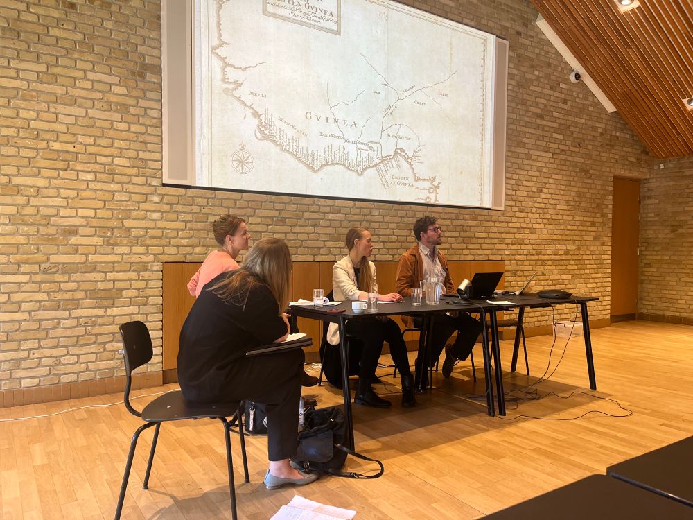Four people on a panel at an academic conference