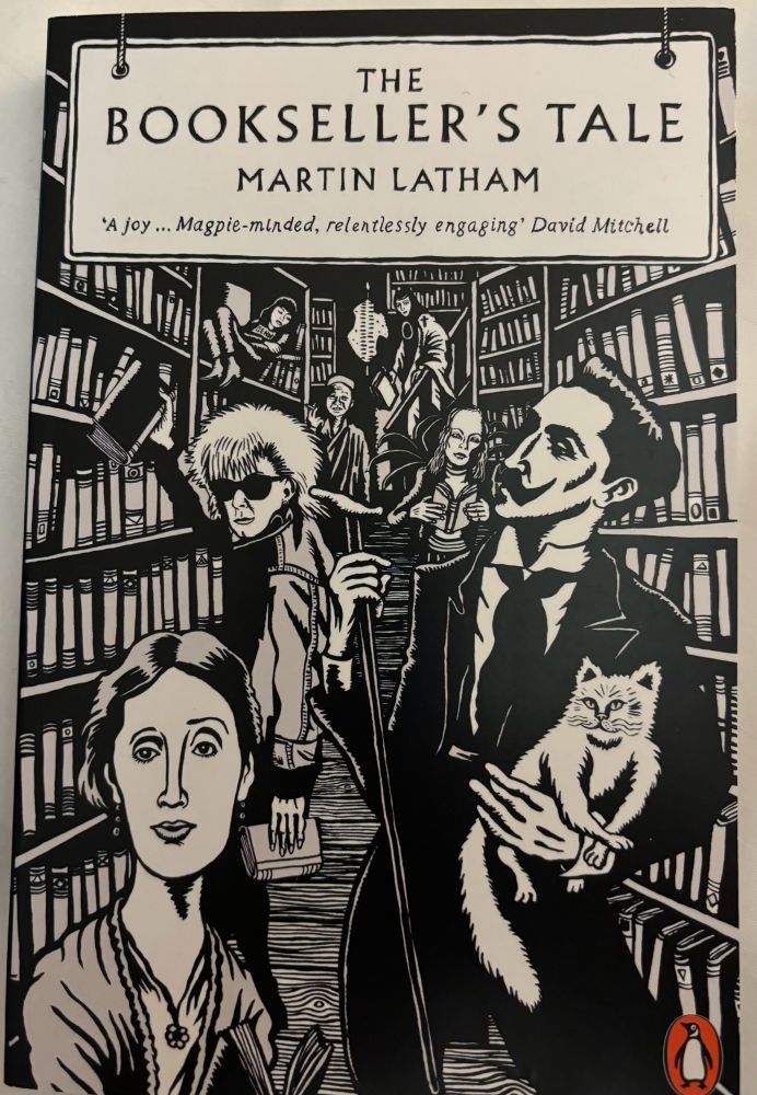 Cover of the book The Booksellers Tale by Martin Latham
Black and white drawing of people- one holding a white cat, browsing between rows of bookshelves 