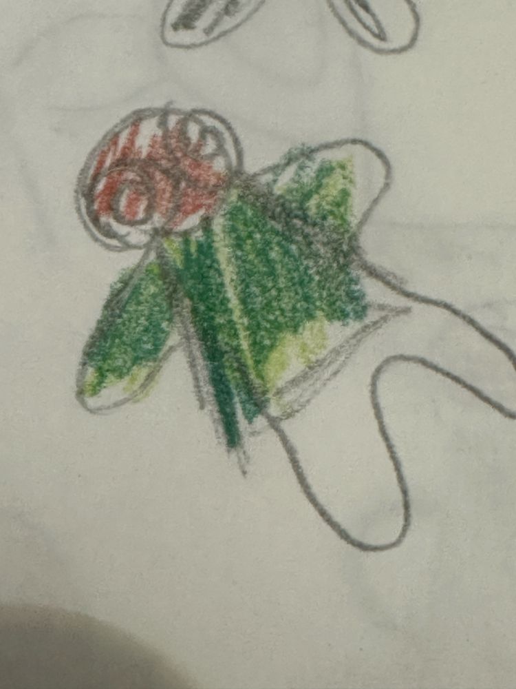 Pencil Drawing Ron Delight from Ace Attorney shaped more or less like a gingerbread cookie, face down on the ground. He has red brown hair with swirls and a green coat. His pants are white.