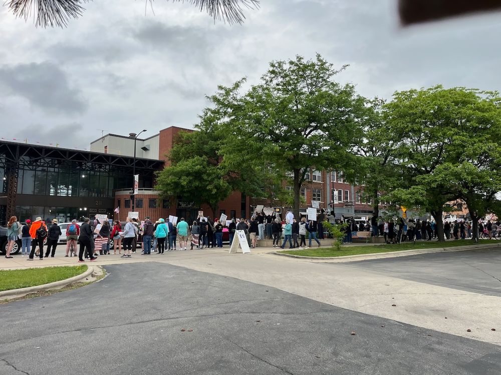 Dozens of people lined up on Broadway Street protesting Trump at a No Kings rally in Green Bay.