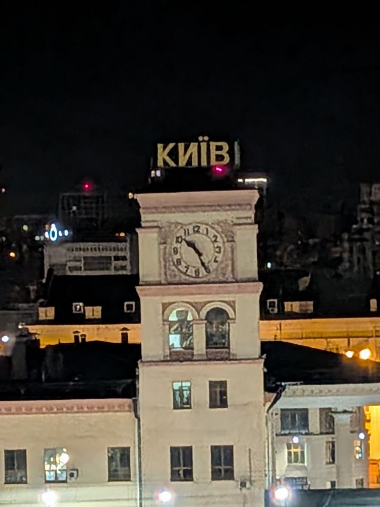 Railway clock showing 10:25 pm.