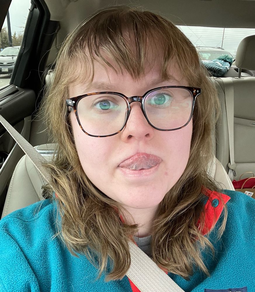 selfie of me with my new haircut which includes bangs. stuck out my tongue in a funny way