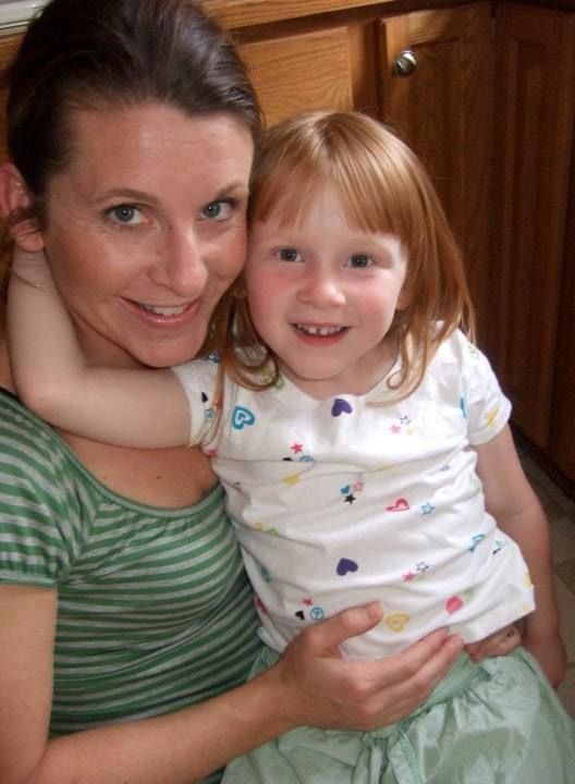 Carrie holding Claire on her lap. She is apx 4 years old. 