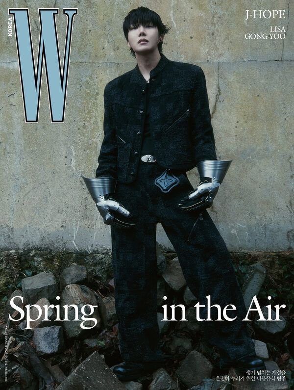 Jhope wearing black jacket over black shirt paired with Black trousers with metal gloves 