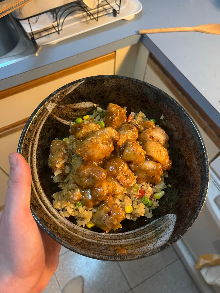 Air fried orange chicken over cauliflower rice and mixed vegetables 