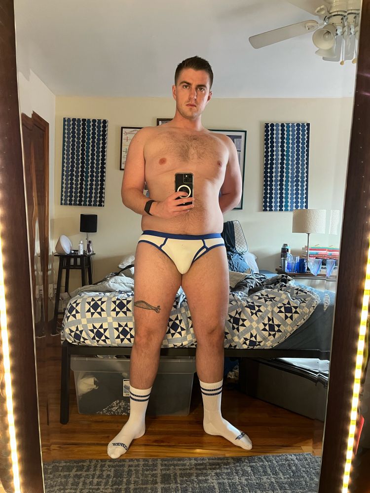 Sam in blue and white fly-front briefs and matching socks. He is sporting a new haircut.
