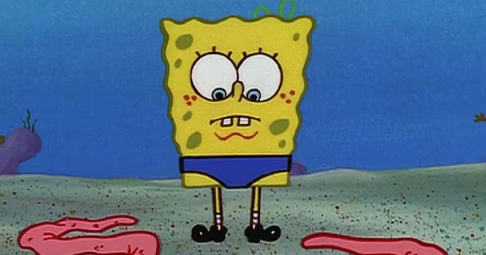 SpongeBob, armless, with his giant inflatable muscle arms on the ground