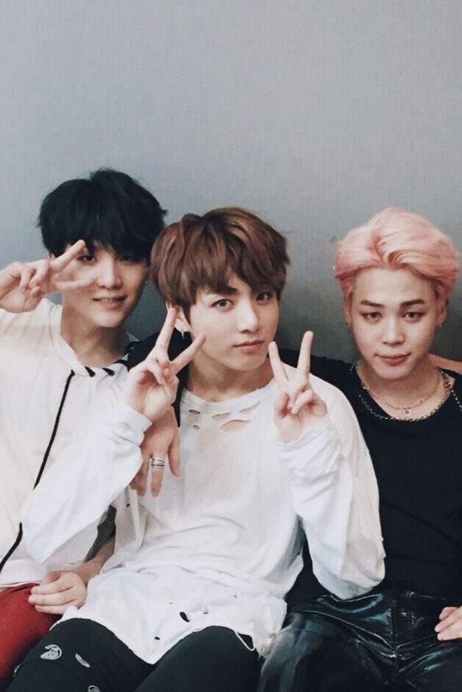 Black haired Yoongi making a peace sign over his eye.

Brown haired Jungkook making double peace signs.

Pink haired Jimin with his arm around Jungkook.