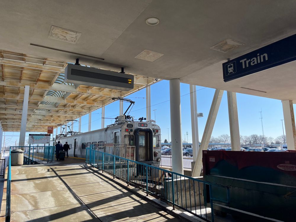 The train at the platform with a wider vantage point.
