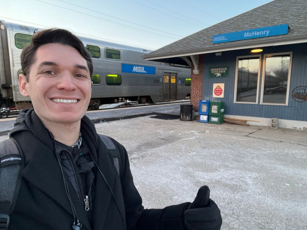 Standing in front of a Metra train and the McHenry station platform.