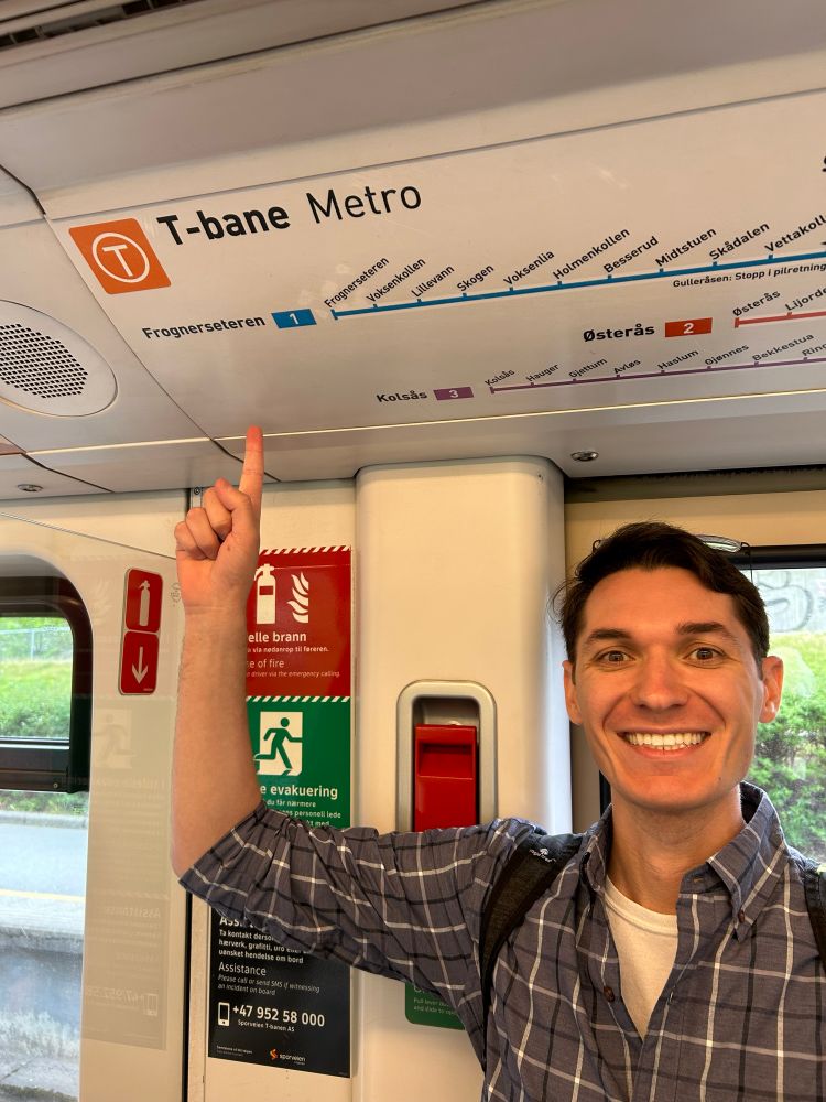 Pointing to the T-Bane Metro sign with a T logo looking akin to the MBTA T logo.