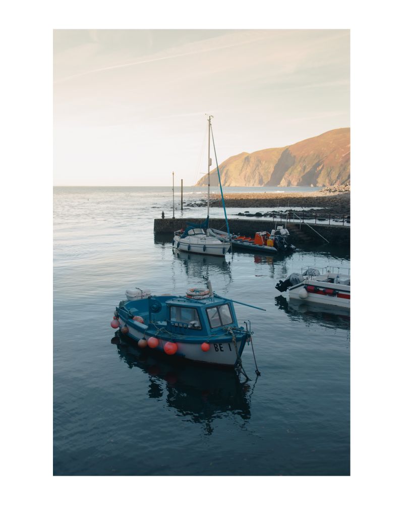 Late evening sun. Looking over the harbour with cliffs in the distance. Lynmouth, North Devon. 