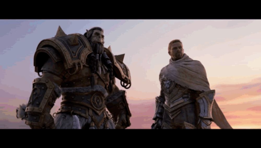 two men in armor are standing next to each other in front of a sunset