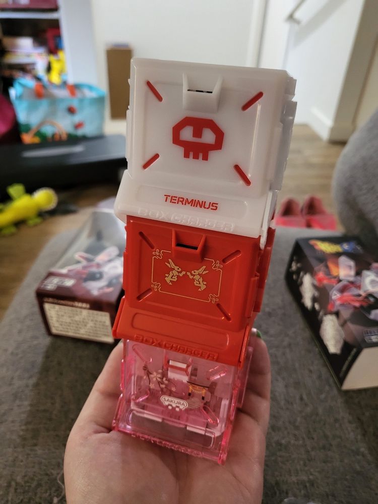 Three plastic boxes of different colors stacked vertically 