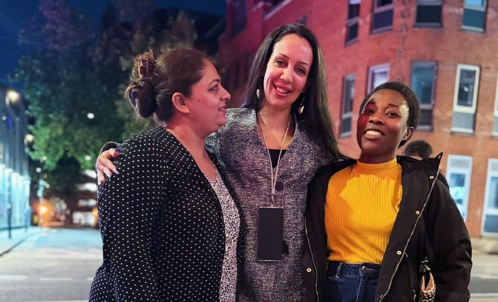 Three people together outside 