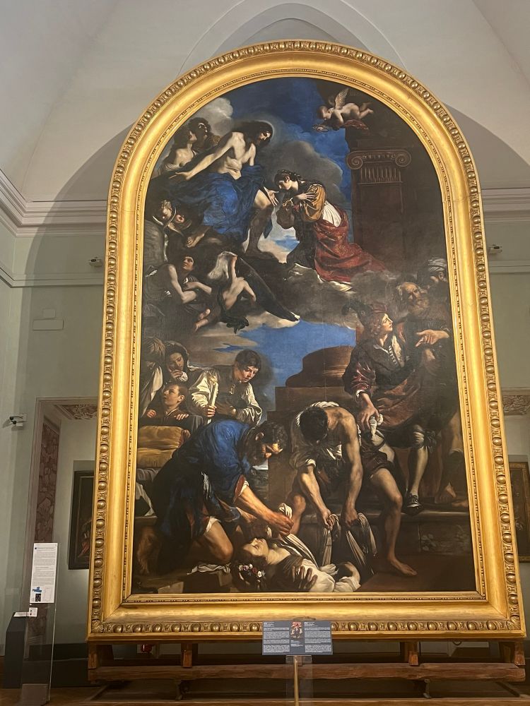 Picture of the painting Burial of Saint Petronilla by Guercino which has an enormous frame painted gold 