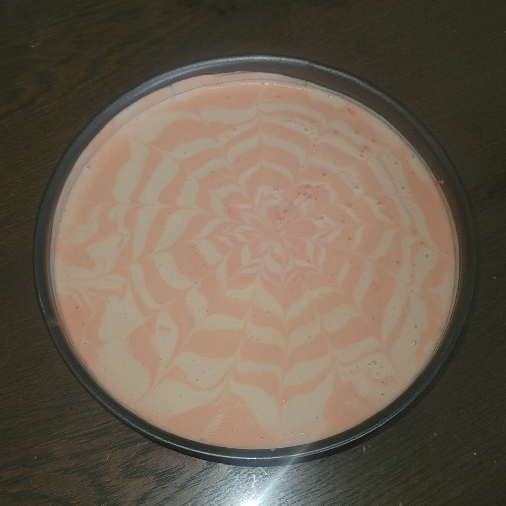 Picture of a kwarktaart (no-bake cake that is somewhat similar to no-bake cheesecake but made with quark rather than cream cheese) with pale yellow and pale orange marbling.